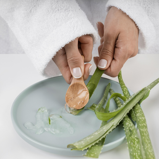 close-up-hands-taking-aloe-vera-gel